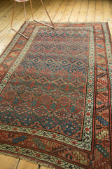 Antique Kurdish Bijar corner showing geometric henna motifs, red, blue, green, even pile.
