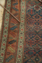 Hand-knotted Kurdish Bijar rug's stylized henna plant design in indigo, copper, and saffron.