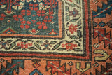 Antique Kurdish Bijar rug detail, indigo field with red henna plant motif and multi-color stylized borders.