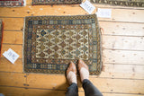 Collectible hand-knotted Caucasian rug, lattice diamond motif in light blue, gold, and charcoal. 1'11