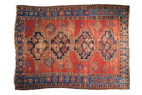 Hand knotted vintage Caucasian carpet, terra cotta field, indigo stepped medallions, wear.