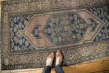 Antique Malayer rug detail: elongated hexagonal medallion, blush, blue, brown Herati motifs, with light foundation showing.