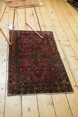 Intricate floral vines and patterned border on a vintage cranberry red German Sarouk runner.