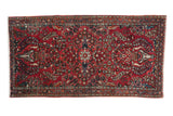 Vintage Persian Sarouk runner in cherry red with roundel medallion and vase of life motifs.