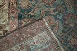 Vintage Malayer rug's hand-knotted foundation, secured side cording, and patterned pile.