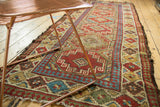 Antique Caucasian runner's geometric Laleh Abassi pawn border detail with characteristic fringe wear.