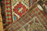 Antique Caucasian rug: primitive geometric gul panels and woven foundation.