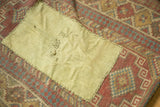 Stitched fabric patch detailing areas of wear on an Antique Caucasian geometric rug.