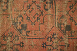 Close-up of the antique Ensi rug's geometric gul motif with worn knot heads.