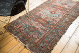 Vintage Persian Mehriban rug with oversized Caucasian-inspired designs; dusty magenta, rust, teal.