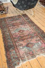 Vintage Mehriban rug: dusty magenta field, sky blue oversize motifs, worn foundation, tattered end.
