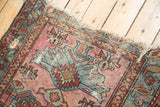 Vintage Mehriban rug: tattered ends, worn side, visible foundation through geometric patterns.
