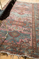 Hard tatter to ends of Mehriban rug, with geometric border in terra cotta and blue.