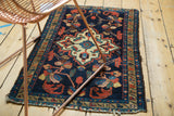 Vintage Borchalou rug: ivory quatrefoil medallion with geometric floral blossoms, indigo field.