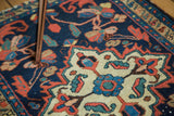 Vintage Borchalou rug's ivory quatrefoil medallion and indigo field with floral designs.