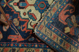 Folded vintage Borchalou rug revealing indigo, terra cotta geometric floral pile and its foundation.