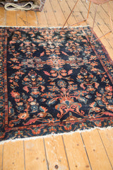 Indigo field of vintage Lilihan rug with expressive floral palmettes and contouring.
