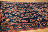 Vintage Lilihan rug detail: indigo field, expressive floral palmettes, and wine red border.