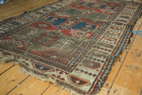 Storied wear and threadbare texture on an antique Caucasian rug section with geometric guls.