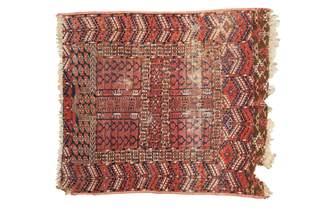 Antique Turkmen square rug, red, navy, ivory geometric design, with worn ends and hole.