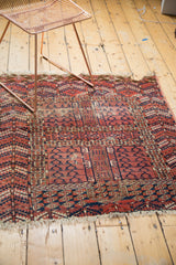 Geometric motifs, serrated borders, and worn edge of an antique Turkmen rug.