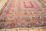 Antique Mudjur rug's tattered fringe and visible foundation at corner, featuring geometric borders.