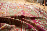 Folded late 19th century Mudjur prayer rug with magenta, pistachio green, and ivory patterns.