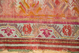 Aged lower border of antique Mudjur rug, showing magenta, green geometric motifs and foundation.