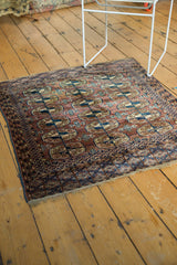 Hand-knotted vintage Turkmen rug corner, Bokhara gul motif in indigo and blush apricot.