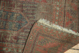 Antique Belouch rug corner detail showing indigo and red pile, restrung fringe, and tightly woven foundation.