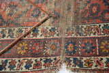 Vintage Caucasian runner with visible foundation and tattered geometric border.