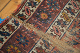 Aubergine and navy geometric flower patterns with visible pile loss and exposed foundation.