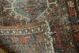 Multi-color selvage, worn pile, and tattered fringe on a vintage Karaja rug runner.