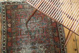 Vintage Karaja rug detail: cherry red, mallard green geometric motifs and multi-color selvage.
