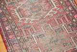 Vintage Karaja rug detail: geometric patterns, dusty black cherry, navy, ivory, and visible wear.