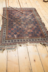 Hard tatter on the end fringe of the antique Belouch rug with geometric border patterns.