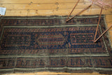 Antique Belouch runner section highlighting indigo field, aubergine pawn design, and tattered fringe.