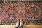 Vintage Persian Mehriban runner: brick red field with multi-color Mina Khani floral pattern and wear.