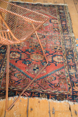 Mina Khani floral patterns and vinery in brick red, navy, and teal on a vintage Mehriban rug.