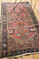 Vintage Mehriban runner, close-up of brick red field with navy border and tattered fringe.