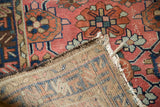 Vintage Mehriban runner detail: hand-knotted foundation, worn brick red pile, tattered fringe.