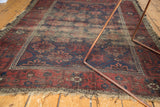 Antique Belouch rug border with figural effigy motifs, indigo and wine red.