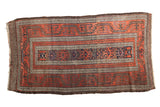 Antique Belouch runner featuring wide banded borders, diminutive center field, warm red, indigo, charcoal.