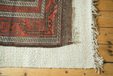 Original plain weave end, ivory fringe, and rich brown border of an antique Belouch runner.