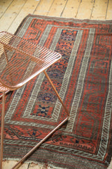 Antique Belouch runner: wide banded borders, geometric red, indigo, brown motifs. Visible wear.