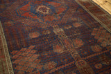 Storied abrasion and etched pile reveal garden motifs in an antique Timuri Belouch rug.