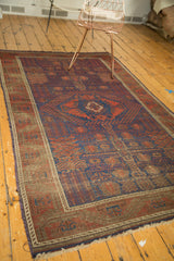 Corner of an antique Timuri Belouch rug showcasing geometric patterns and secured selvedge.