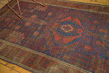 Exotic garden motif of antique Timuri Belouch rug in abrashed navy and pomegranate red.