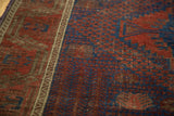 Antique Timuri Belouch rug detail: abrashed navy, pomegranate red stylized garden motifs and geometric border.