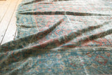 Distressed vintage Mahal carpet, showing blush, sky blue, and green allover floral vinery.
